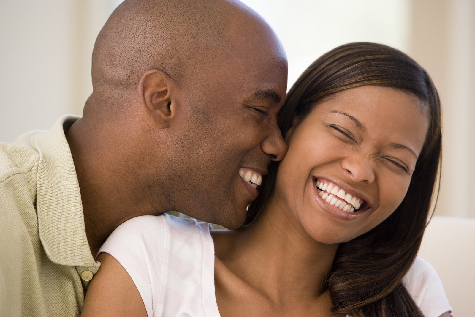 young black couple smiling and laughing nice white teeth. dentist Brooklyn, NY veneers